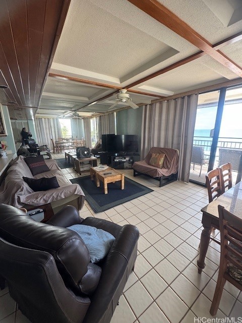 living room featuring light tile patterned floors and coffered ceiling