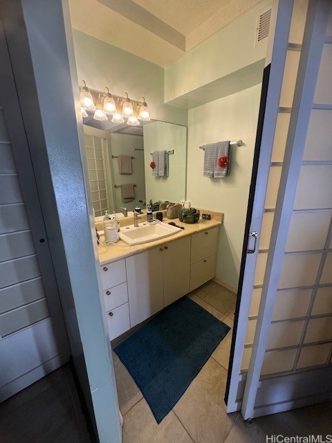 bathroom featuring tile patterned flooring and vanity