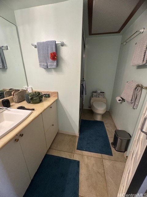 bathroom featuring toilet, tile patterned floors, and vanity