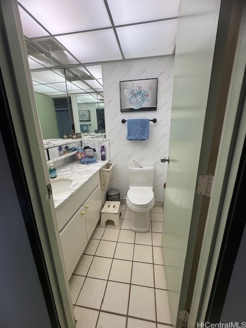 bathroom featuring toilet, vanity, and tile patterned flooring