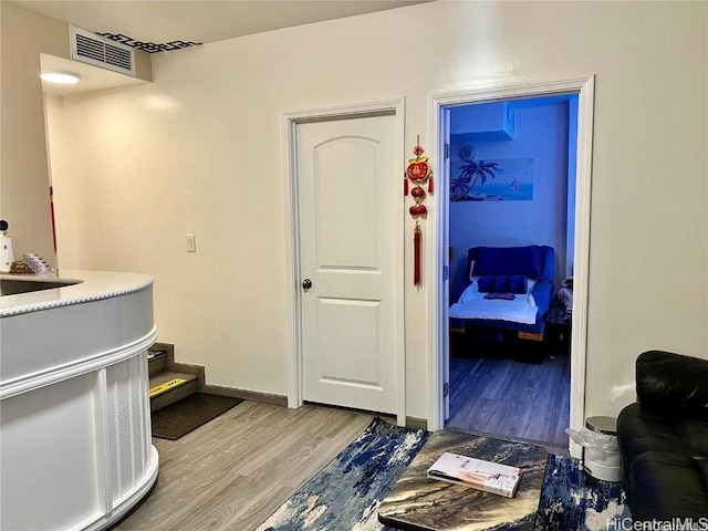 interior space with hardwood / wood-style floors and sink