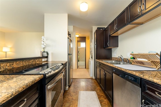 kitchen featuring stone countertops, sink, dark brown cabinetry, and appliances with stainless steel finishes