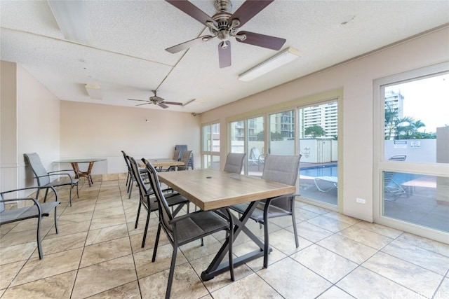 tiled dining area with a textured ceiling