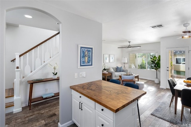 kitchen featuring ceiling fan, white cabinetry, wooden counters, and dark wood-type flooring