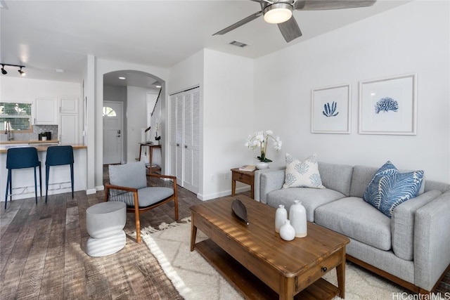 living room with ceiling fan and light hardwood / wood-style flooring