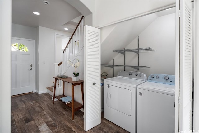 clothes washing area with independent washer and dryer and dark wood-type flooring