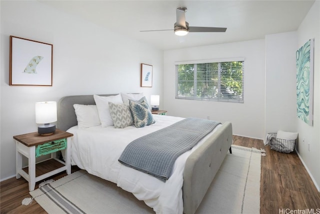 bedroom with dark wood-type flooring and ceiling fan