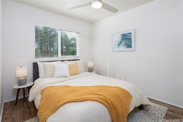 bedroom with ceiling fan and dark hardwood / wood-style floors