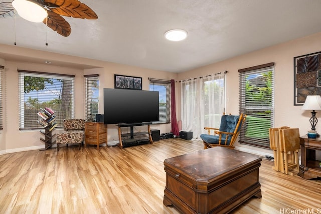 living room with ceiling fan and light hardwood / wood-style flooring