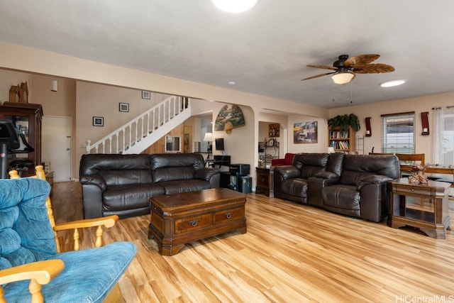 living room featuring ceiling fan and light wood-type flooring