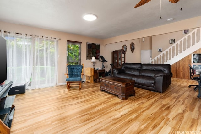 living room with light hardwood / wood-style floors and ceiling fan