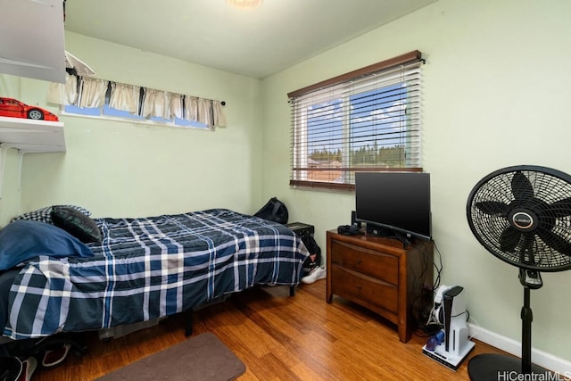 bedroom with hardwood / wood-style floors