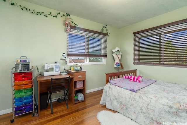 bedroom with hardwood / wood-style flooring