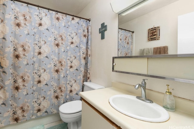 bathroom featuring toilet, vanity, and curtained shower