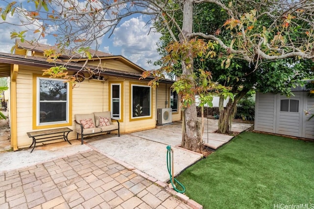 rear view of house with a patio area, a storage shed, and a lawn