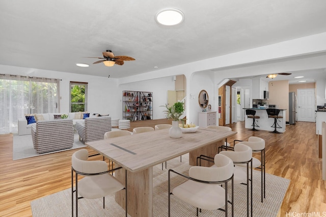 95-528 Awiki St, Mililani, HI 96789 - dining space featuring ceiling fan, arched walkways, and light wood-style floors