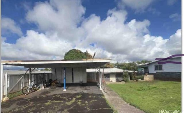 exterior space with a carport and a yard