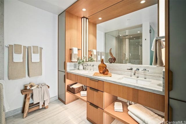 bathroom featuring an enclosed shower and vanity