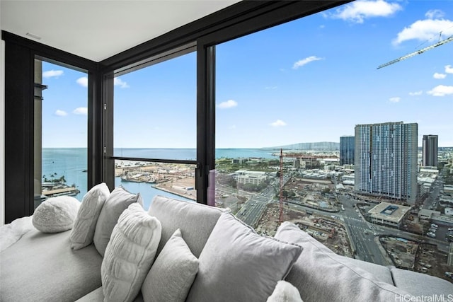 sunroom featuring a water view