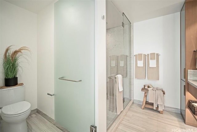 bathroom featuring an enclosed shower, vanity, toilet, and hardwood / wood-style flooring