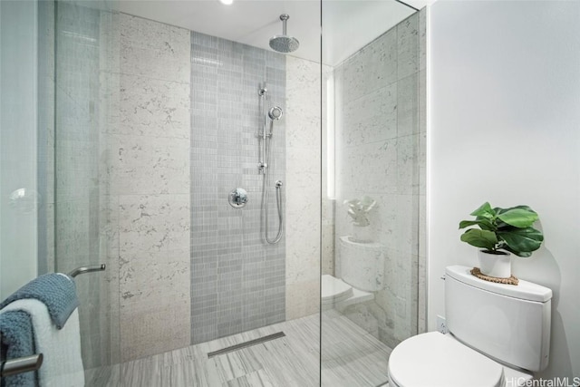 bathroom featuring an enclosed shower and toilet