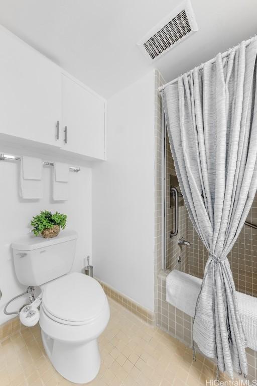 bathroom with toilet and tile patterned flooring