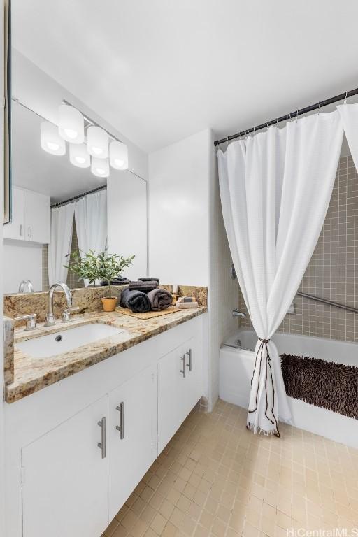 bathroom featuring vanity and shower / tub combo with curtain