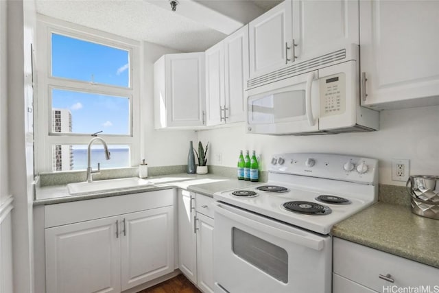 kitchen featuring sink, white cabinets, and white appliances