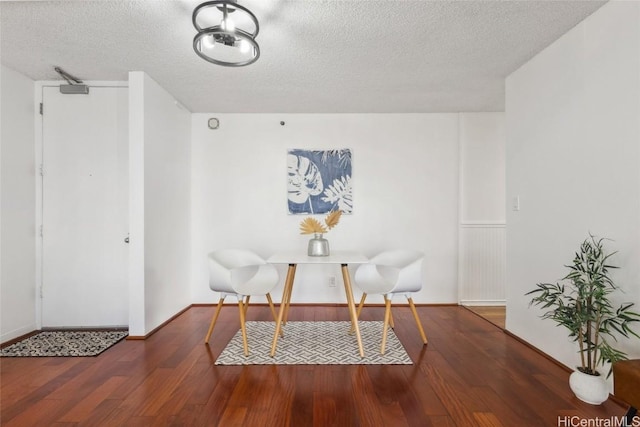 sitting room featuring a textured ceiling and dark hardwood / wood-style flooring