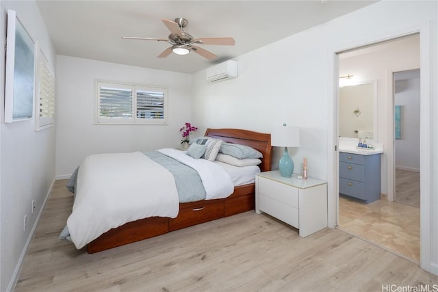 bedroom featuring ceiling fan, connected bathroom, light hardwood / wood-style floors, and an AC wall unit