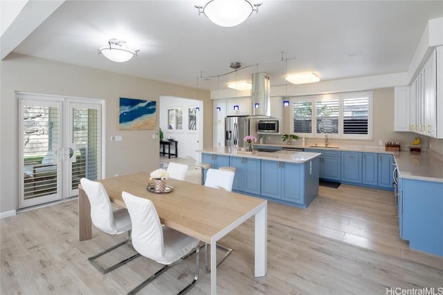 dining space featuring sink and light hardwood / wood-style flooring