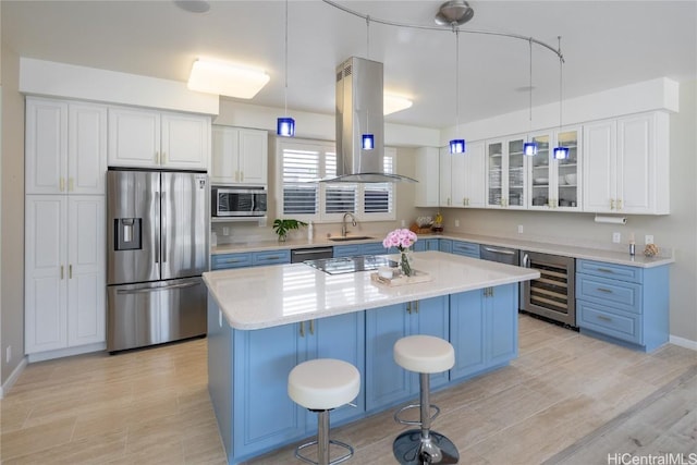 kitchen with sink, hanging light fixtures, a kitchen island, stainless steel appliances, and island exhaust hood