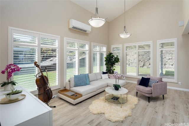 living room with high vaulted ceiling, a wall mounted AC, and light wood-type flooring