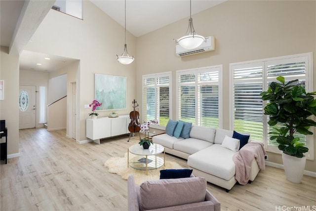 living room featuring a wall mounted AC, high vaulted ceiling, and light hardwood / wood-style flooring