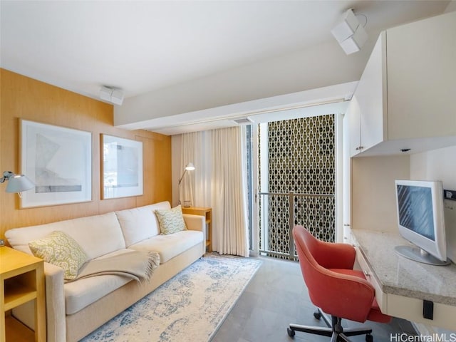 office area featuring wooden walls and a wealth of natural light