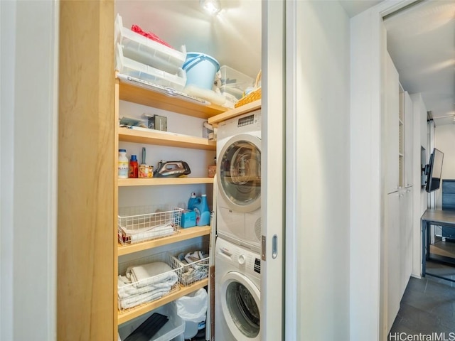 clothes washing area with stacked washer and clothes dryer