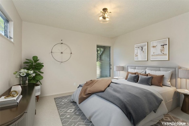 bedroom featuring carpet floors and a textured ceiling