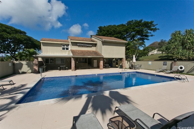 view of pool with a fenced in pool, a patio area, and fence