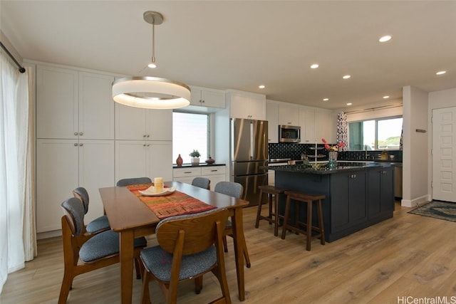 dining room featuring sink and light hardwood / wood-style flooring