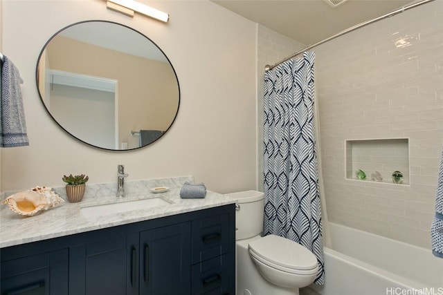 full bathroom with vanity, shower / bath combo, and toilet