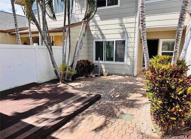 view of side of property with fence and a wooden deck