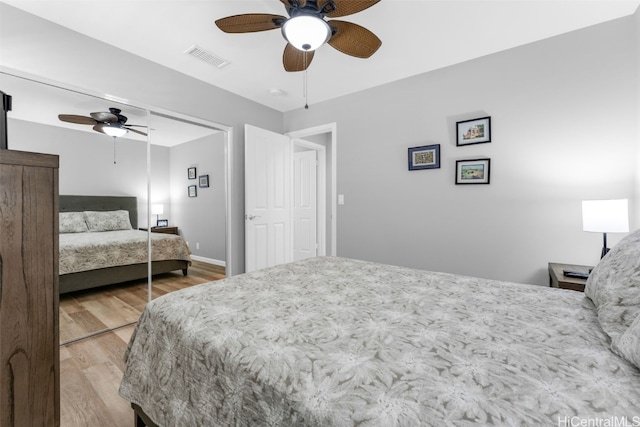 bedroom featuring ceiling fan, wood-type flooring, and a closet