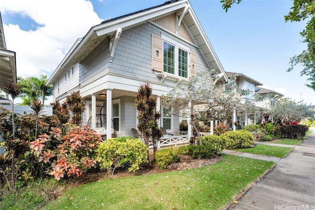 view of front of house featuring a front lawn and covered porch