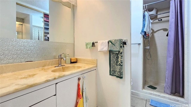 bathroom with vanity, walk in shower, and tile patterned floors