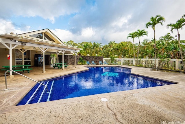 community pool featuring fence and a patio area