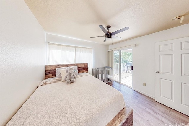 bedroom featuring a ceiling fan, a textured ceiling, light wood-style flooring, baseboards, and access to outside