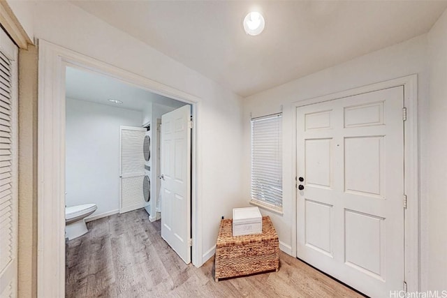 foyer entrance with light wood finished floors and baseboards