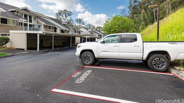 uncovered parking lot with a residential view