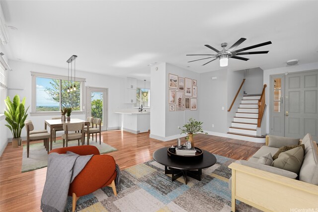 94-1092 Kikepa St Unit 179, Waipahu, HI 96797 - living room with stairway, light wood-style flooring, and a ceiling fan