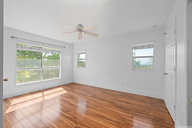 94-1092 Kikepa St Unit 179, Waipahu, HI 96797 - empty room with plenty of natural light, wood finished floors, and a ceiling fan